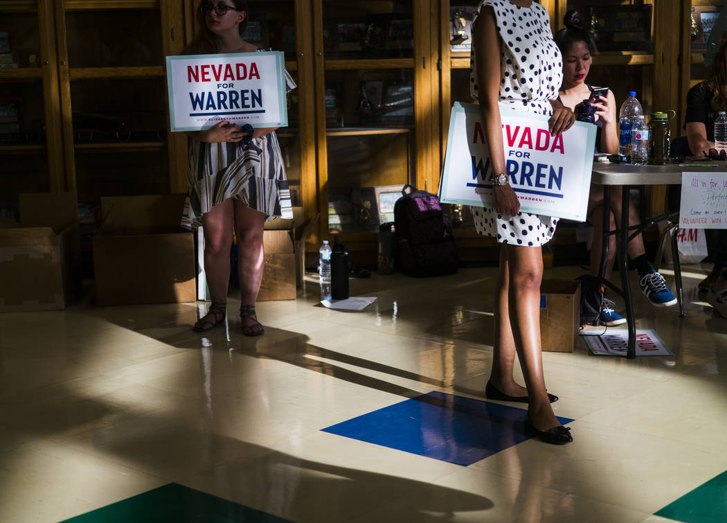Volunteers hold signs in support of Democratic presidential candidate Sen. Elizabeth Warren, D- ...