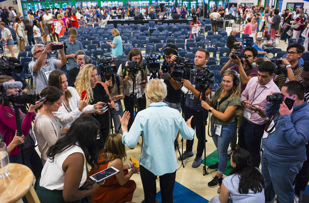 Democratic presidential candidate Sen. Elizabeth Warren, D-Mass., talks with members of the new ...