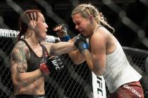 Cris "Cyborg" Justino, left, connects with a left hook against Yana Kunitskaya during their fea ...