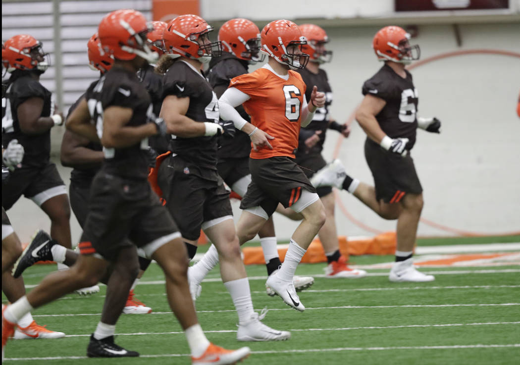 FILE - In this May 4, 2018, file photo, Cleveland Browns quarterback Baker Mayfield (6) runs a ...