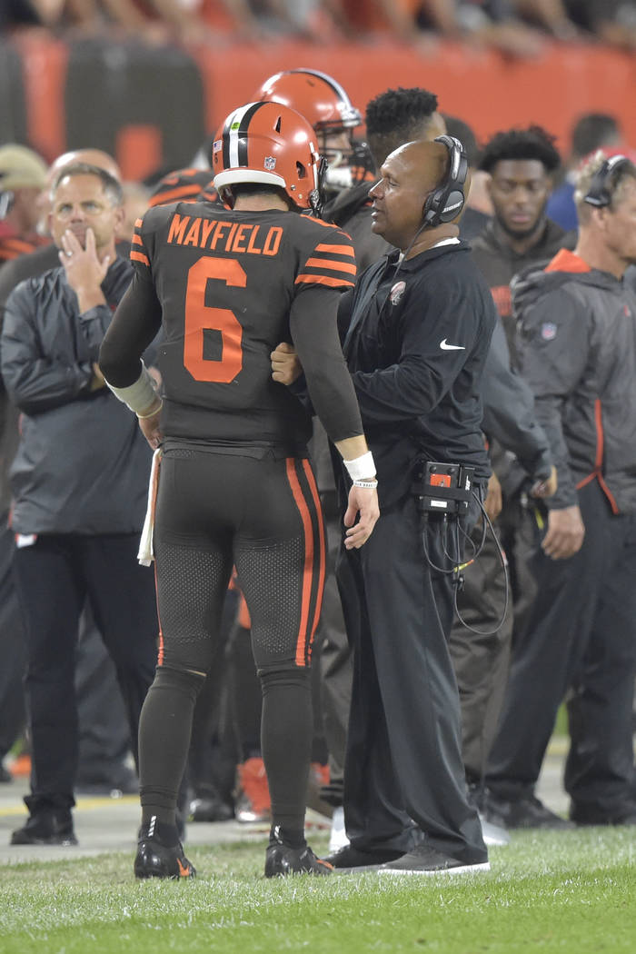 Cleveland Browns quarterback Baker Mayfield talks with head coach Hue Jackson during an NFL foo ...