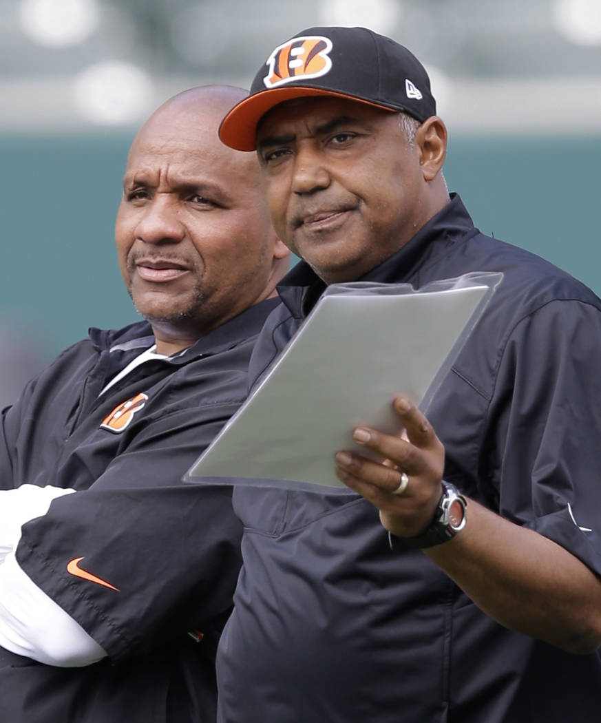 FILE - In this June 3, 2014, file photo, Cincinnati Bengals head coach Marvin Lewis, right, tal ...