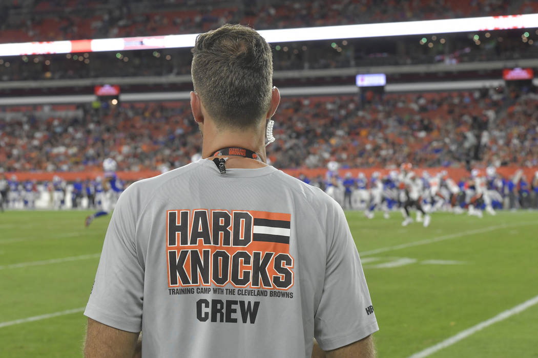 A crew member of the HBO series Hard Knocks stands on the sideline during an NFL football prese ...