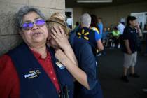 Walmart employees react after an active shooter opened fire at the store in El Paso, Texas, Sat ...