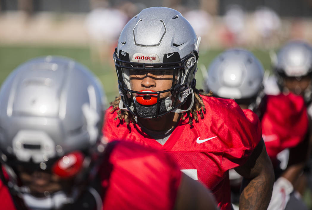 UNLV defensive end/linebacker Gabe McCoy, second from left, works through drills during the fir ...