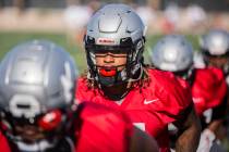 UNLV defensive end/linebacker Gabe McCoy, second from left, works through drills during the fir ...