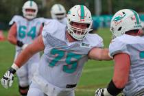 Miami Dolphins tackle Will Holden (75) and offensive guard Jesse Davis run drills at the teams ...