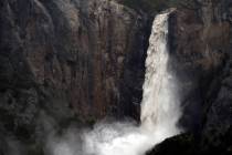 The raging Bridalveil Fall plummets into Yosemite Valley in Yosemite National Park, Calif., in ...