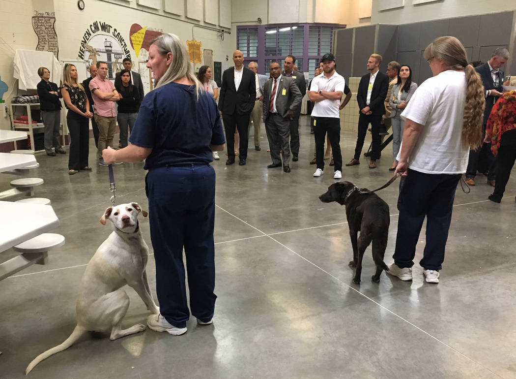 Two inmates who are part of a dog-training program address a tour, which included Democratic pr ...