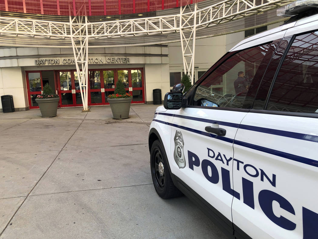 A police cruiser sits outside the Dayton Convention Center, where families of victims were aske ...