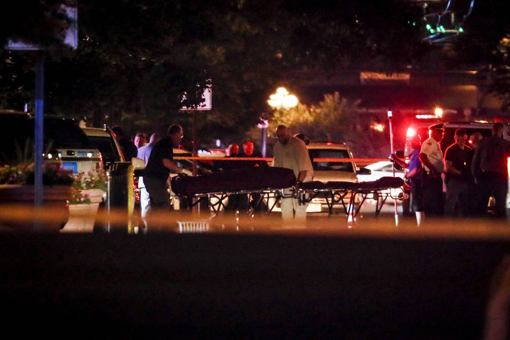 Bodies are removed from at the scene of a mass shooting, Sunday, Aug. 4, 2019, in Dayton, Ohio. ...