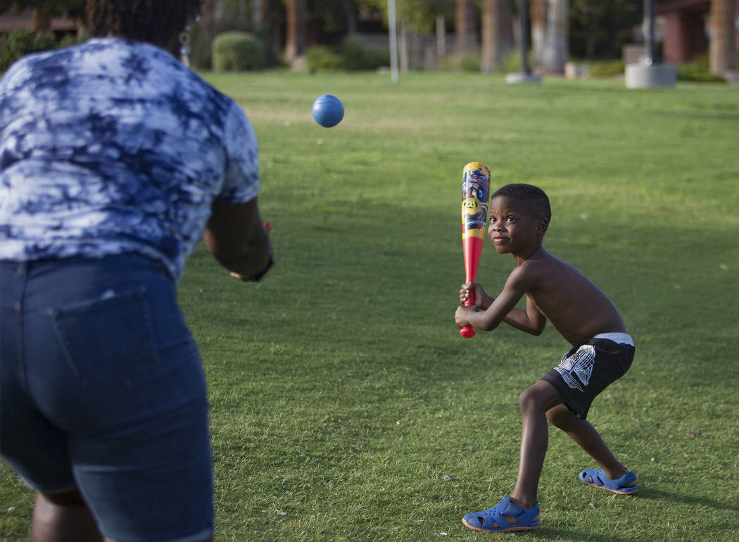 Maureen Edwards tosses a ball to her grandson Xavier Love, 6, at Lorenzi Park in Las Vegas, Sun ...