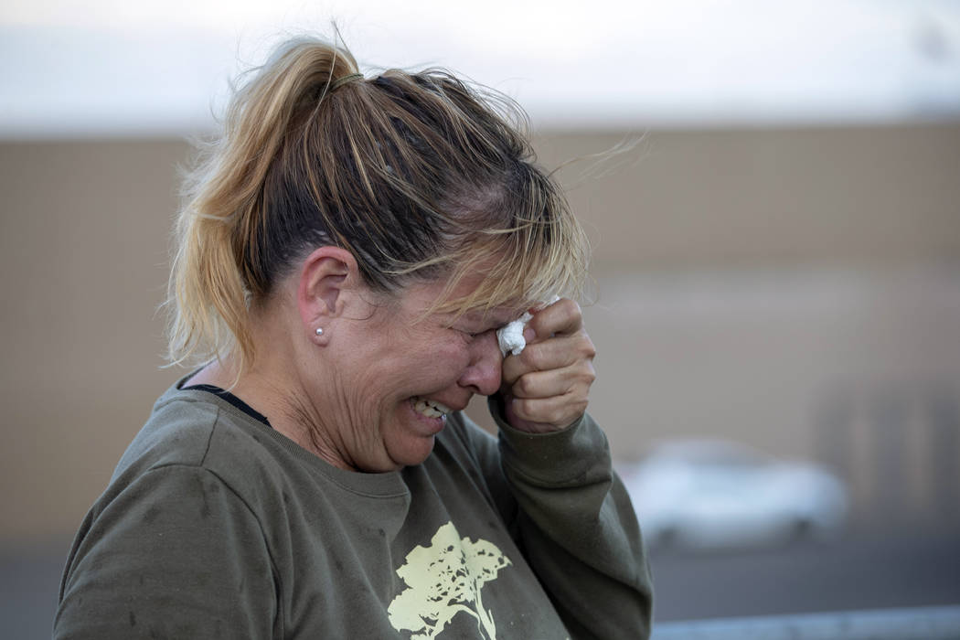 Edie Hallberg cries while speaking to police outside a Walmart store where a shooting occurred ...