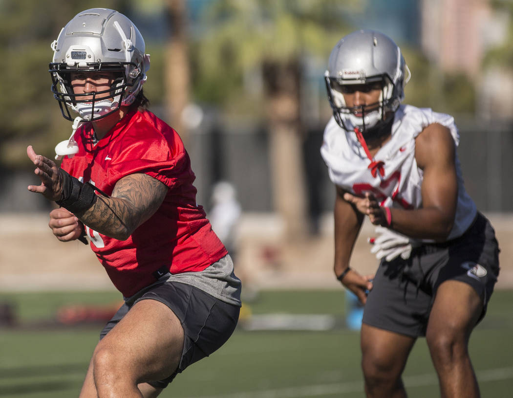 UNLV linebacker Vic Viramontes, left, works through drills during the first day of training cam ...