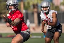UNLV linebacker Vic Viramontes, left, works through drills during the first day of training cam ...