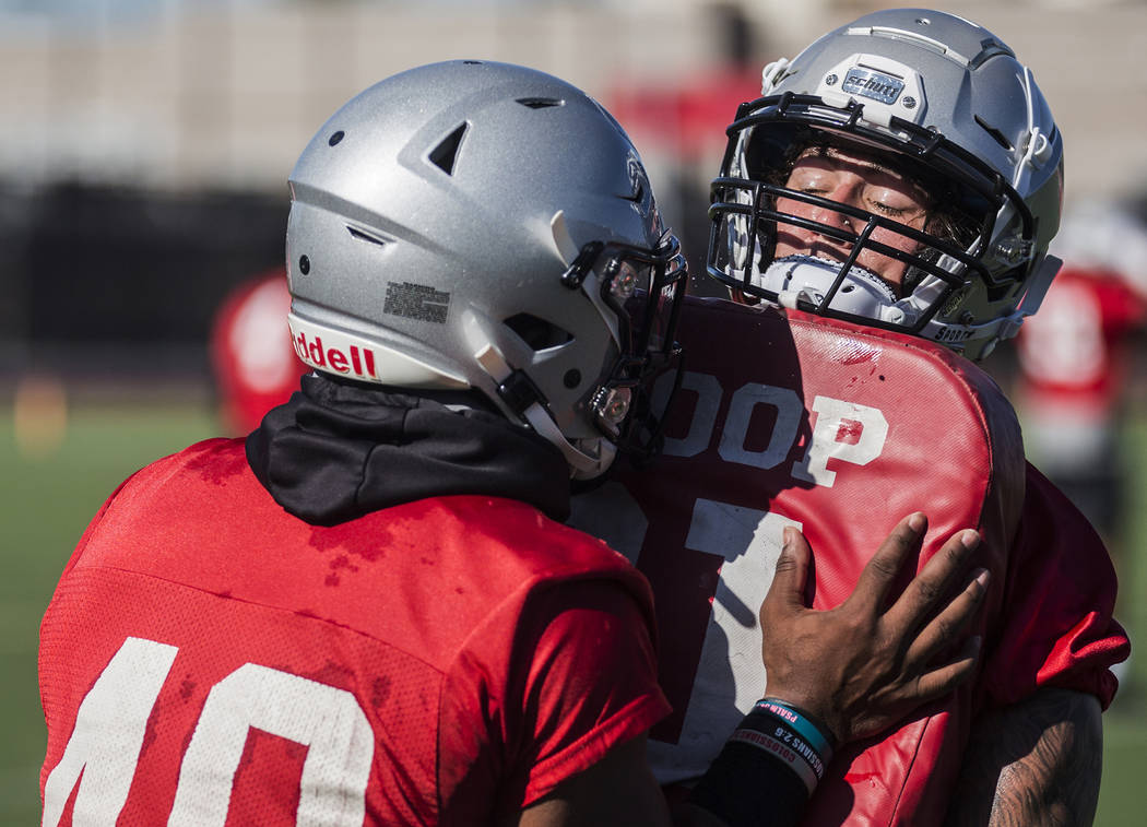 UNLV linebacker Vic Viramontes, right, works through drills during the first day of training ca ...
