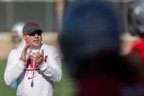 UNLV head football coach Tony Sanchez, left, fires up his team during the first day of training ...