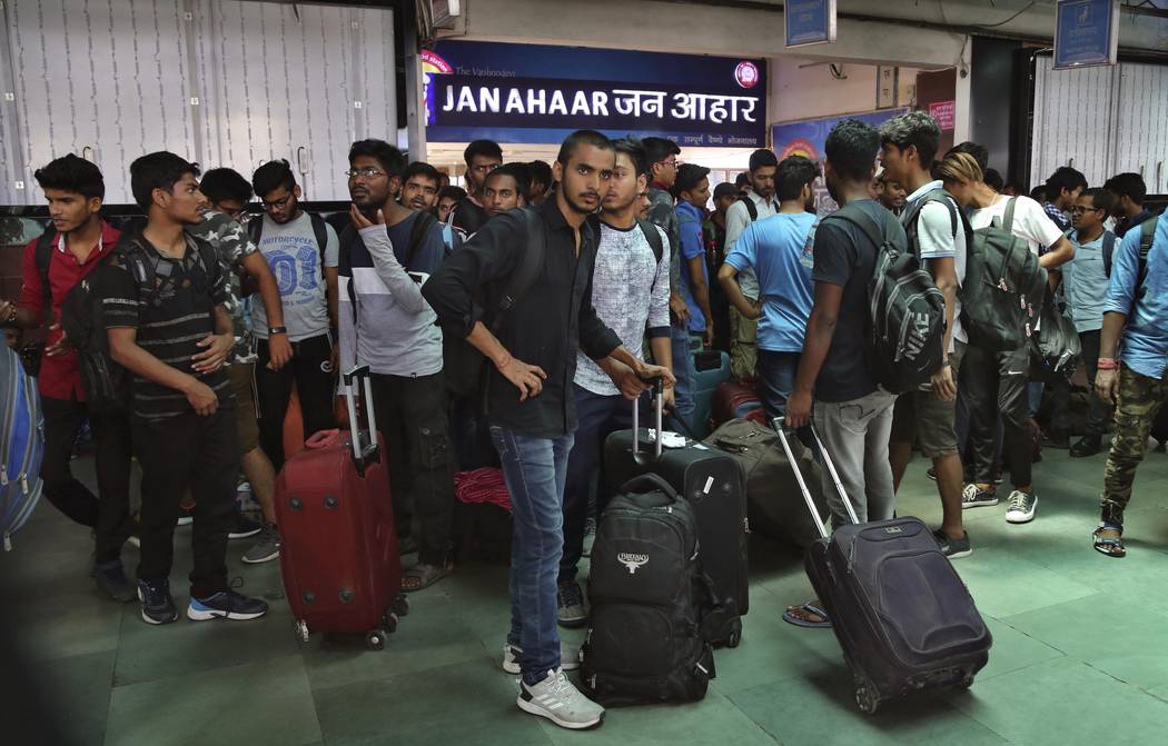 National Institute of Technology (NIT) students who left Srinagar, Kashmir's main city wait to ...