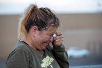 Edie Hallberg cries while speaking to police outside a Walmart store where a shooting occurred ...