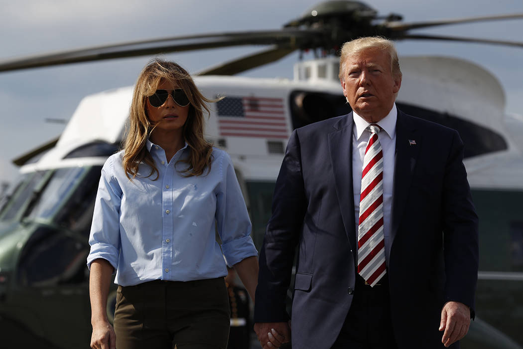 President Donald Trump, with first lady Melania Trump, walks towards the media before speaking ...