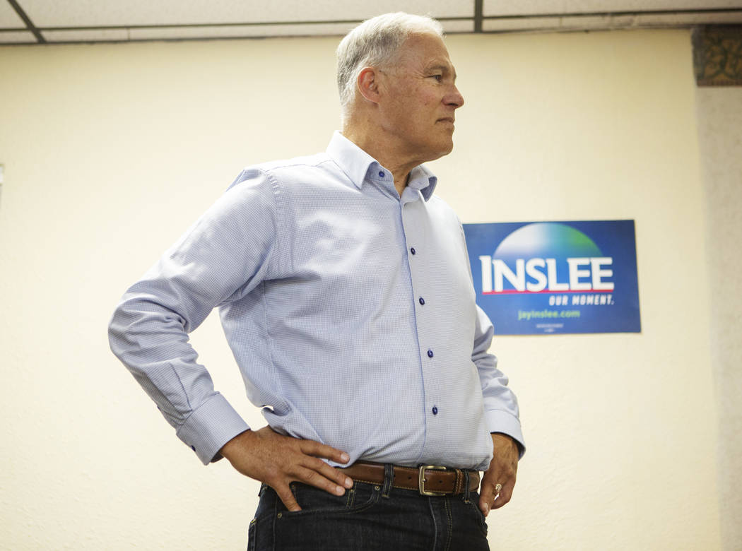 Democratic presidential candidate Washington Gov. Jay listens to audience questions during his ...