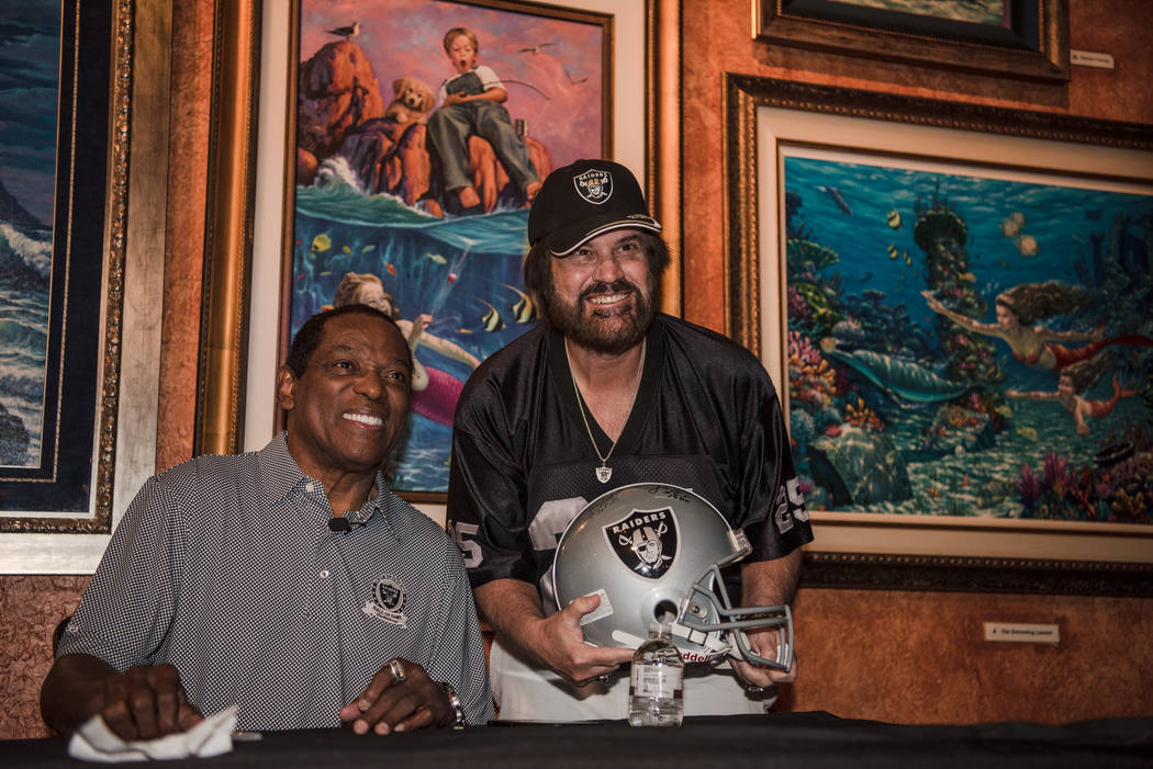 Cliff Branch, a former wide receiver for the Raiders, takes a photo with Art Cook at the Mermai ...