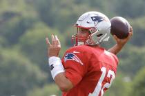 New England Patriots quarterback Tom Brady winds up to pass during an NFL football training cam ...