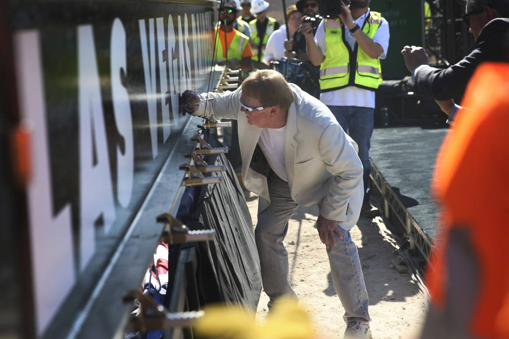 Raiders Owner Mark Davis signs a beam during the Las Vegas Stadium Topping Out Ceremony in Las ...
