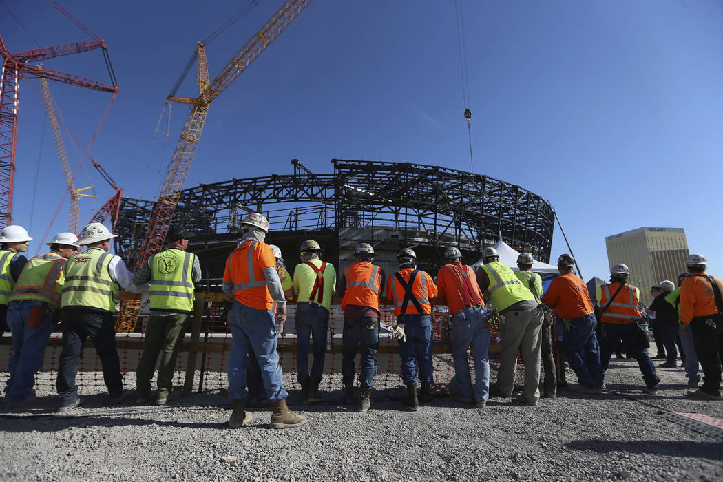 Workers attend the Las Vegas Stadium Topping Out Ceremony in Las Vegas, Monday, Aug. 5, 2019. ( ...