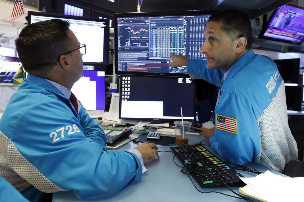 Specialists Paul Cosentino, left, and Jeffrey Berger work on the floor of the New York Stock Ex ...