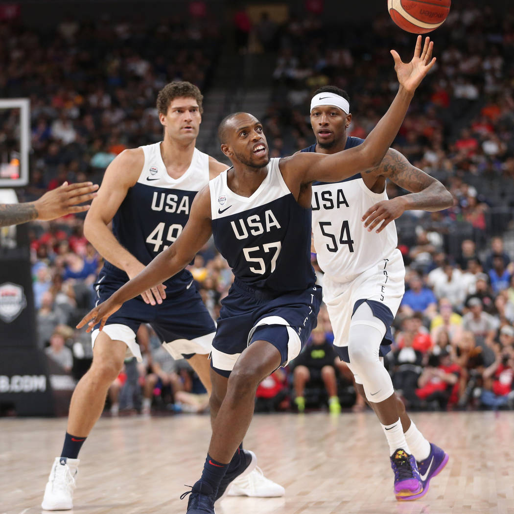 USA Men's National Team Blue forward Khris Middleton (57) reaches for a loose ball as teammate ...