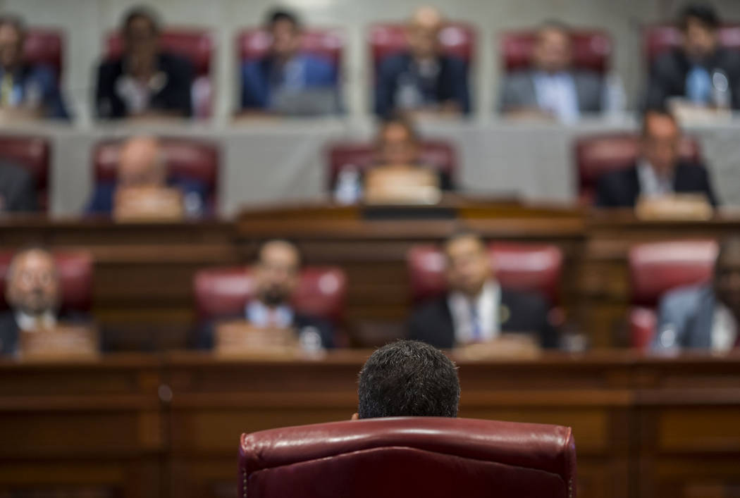 Proposed Secretary of State Pedro Pierluisi (back to camera) speaks during his confirmation hea ...