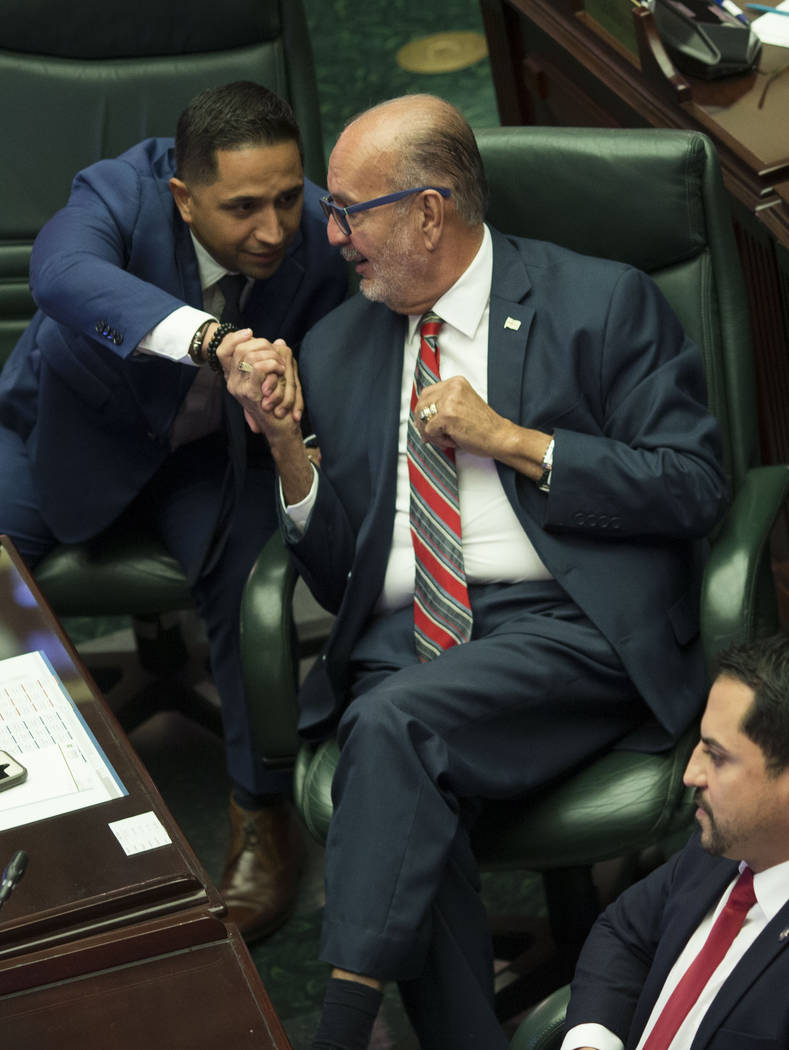 Luis "Junior" Perez, center, shakes hands with fellow lawmakers Urayoan Hernandez as ...