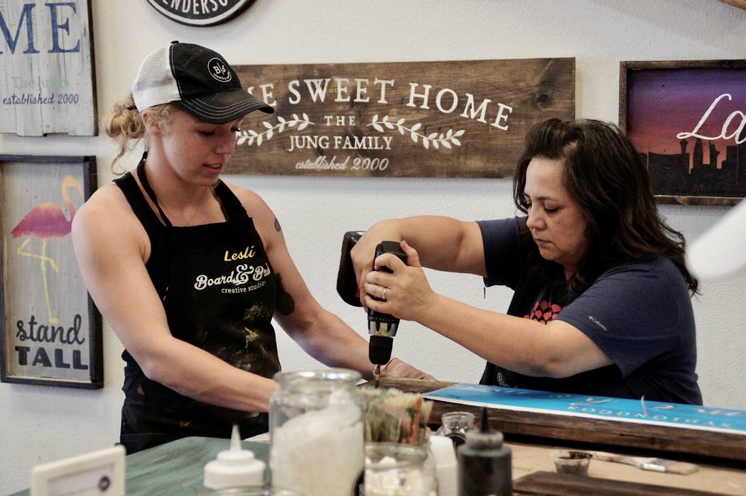 Art Nadler Your Home Lesli Lewis, co-owner of Board & Brush, instructs Rose Sydiongco, right, o ...