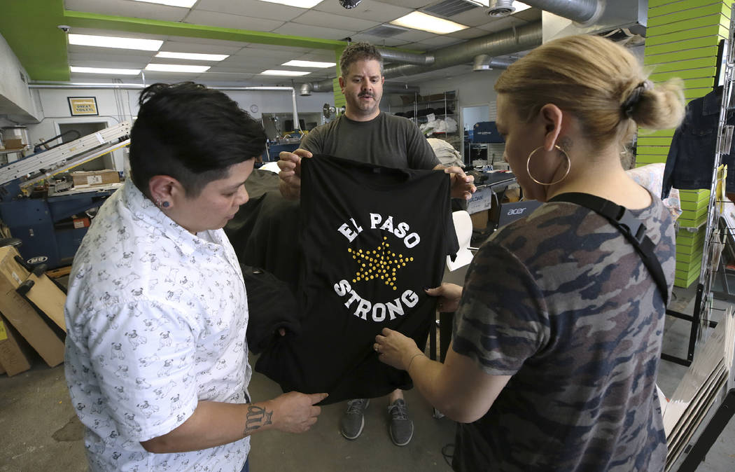 Lisa Basa, left, and Ana Rodriguez buy El Paso Strong t-shirts from Proper Printshop's Alan Hud ...