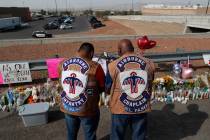 People pray a makeshift memorial for victims of a mass shooting at a shopping complex Monday, A ...