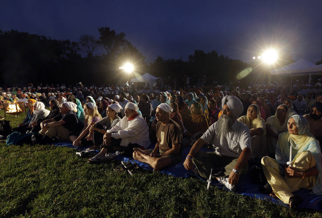 In an Aug. 5, 2013, file photo, hundreds participate in a candlelight vigil at the Sikh Temple ...