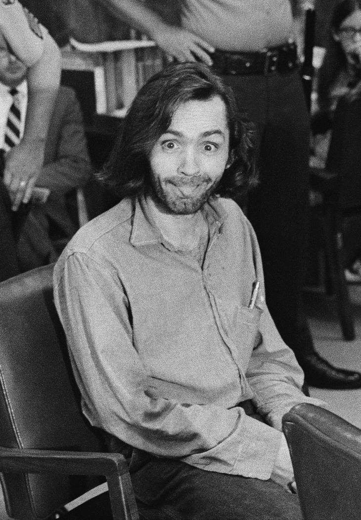 In a June 25, 1970, file photo, Charles Manson sticks his tongue out at photographers as he app ...