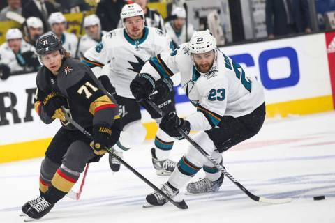 San Jose Sharks right wing Barclay Goodrow (23) skates with the puck under pressure from Golden ...