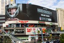 A digital billboard displays Oakland Raiders' Derek Carr in an advertisement for the upcoming s ...