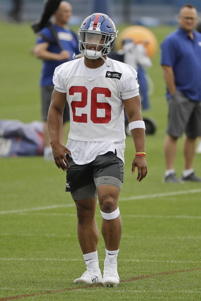 New York Giants' Saquon Barkley (26) warms up at the team's NFL football training facility Wedn ...