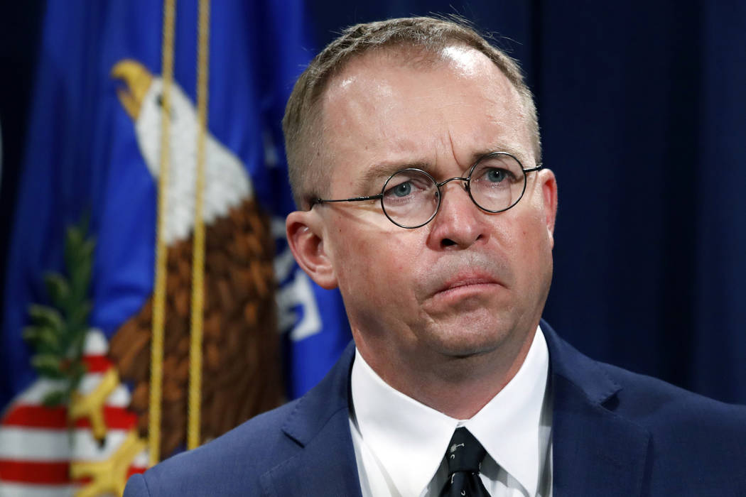 FILE- In this July 11, 2018, file photo Mick Mulvaney, listens during a news conference at the ...