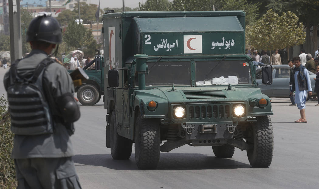 An Afghan military ambulance rushes towards the site of an explosion near police headquarters i ...