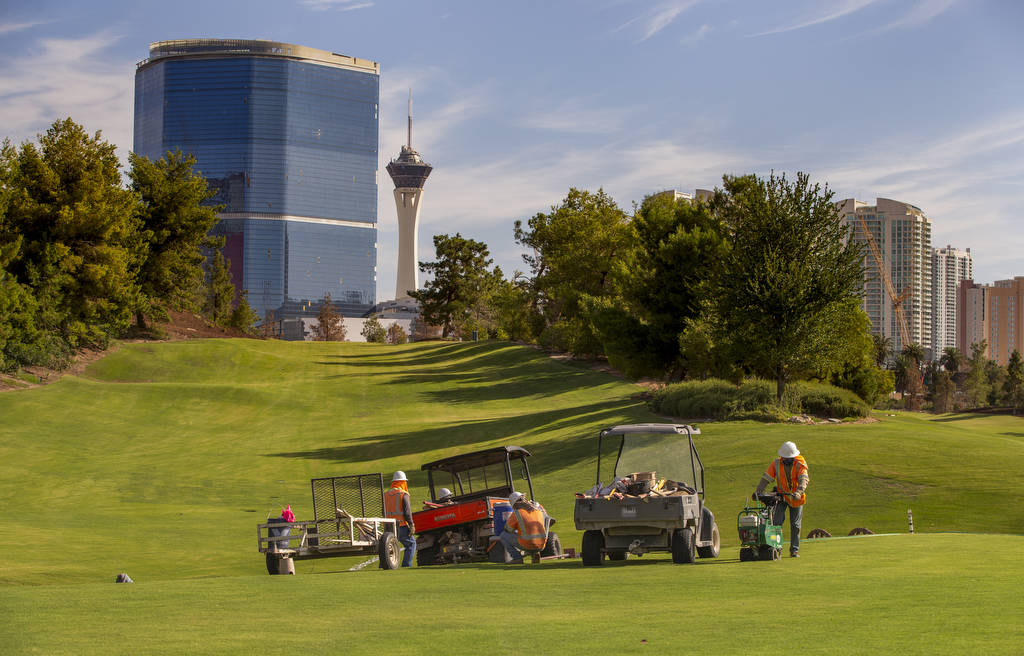 A maintenance crew manicures a green at Wynn Golf Club on Tuesday, July 30, 2019, in Las Vegas. ...