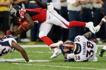 Denver Broncos' Shamarko Thomas (38) tackles Atlanta Falcons' Marcus Green (3) on a punt return ...