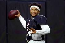 Arizona Cardinals quarterback Kyler Murray smiles as he throws a pass during an NFL football tr ...