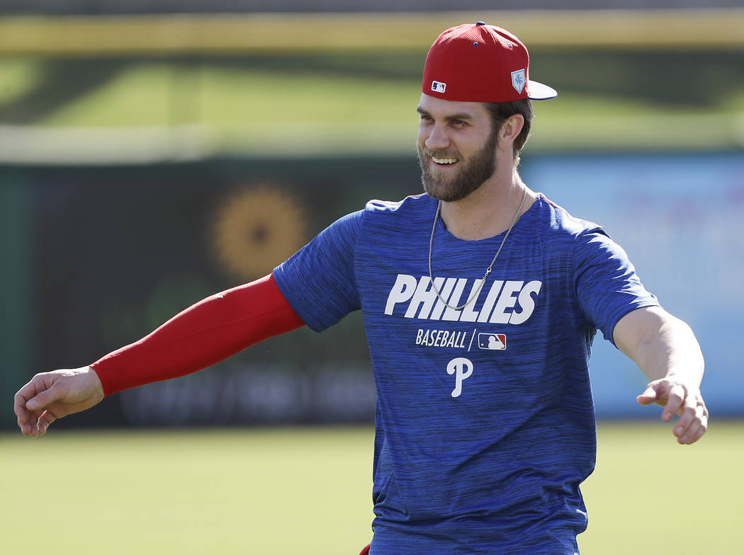 Philadelphia Phillies outfielder Bryce Harper warms up during baseball practice Sunday, March 3 ...