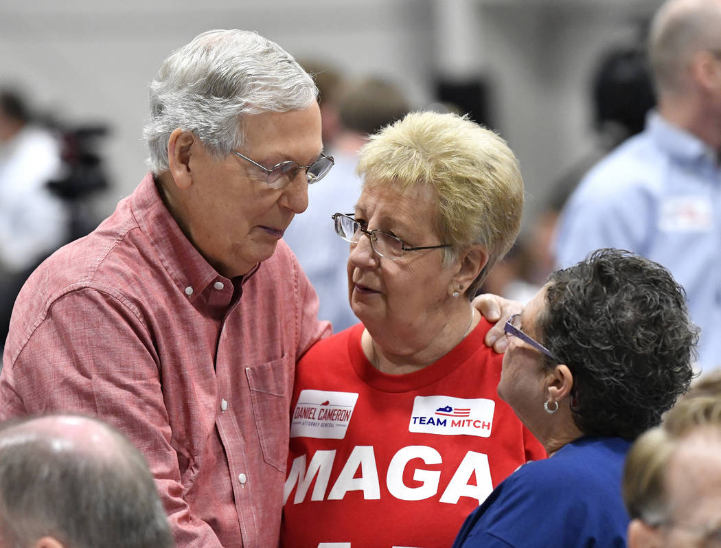Senate Majority Leader Mitch McConnell, R-Ky., left, speaks with supporters before the start of ...