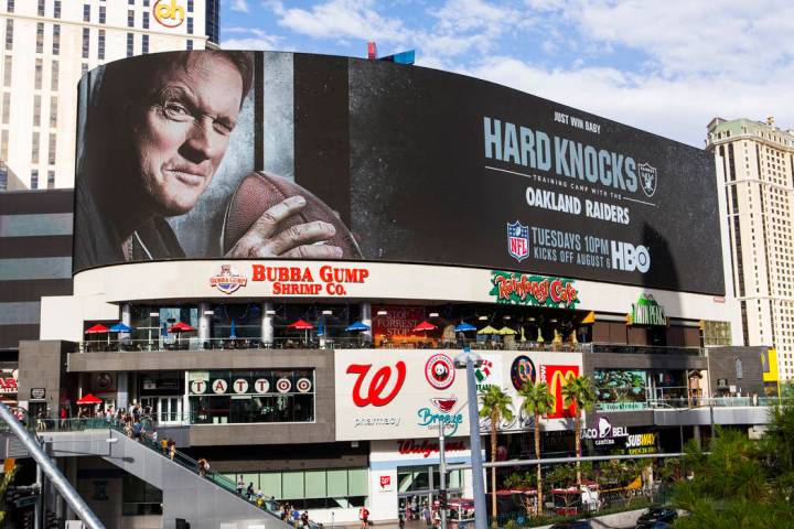 A digital billboard displays Oakland Raiders coach Jon Gruden in an advertisement for the upcom ...
