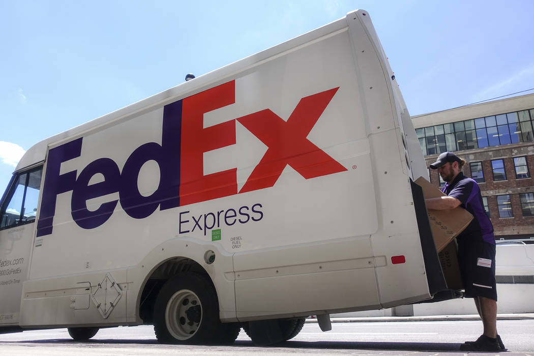FILE - In this June 25, 2019, file photo a FedEx delivery truck is loaded by an employee on the ...